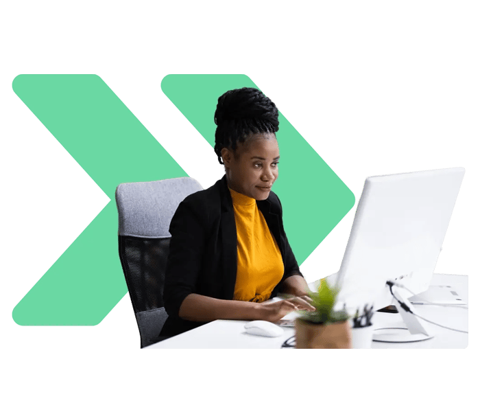 Woman on computer with green arrows behind her