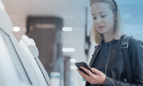 セルフサービス機でコピーする電話中の女性